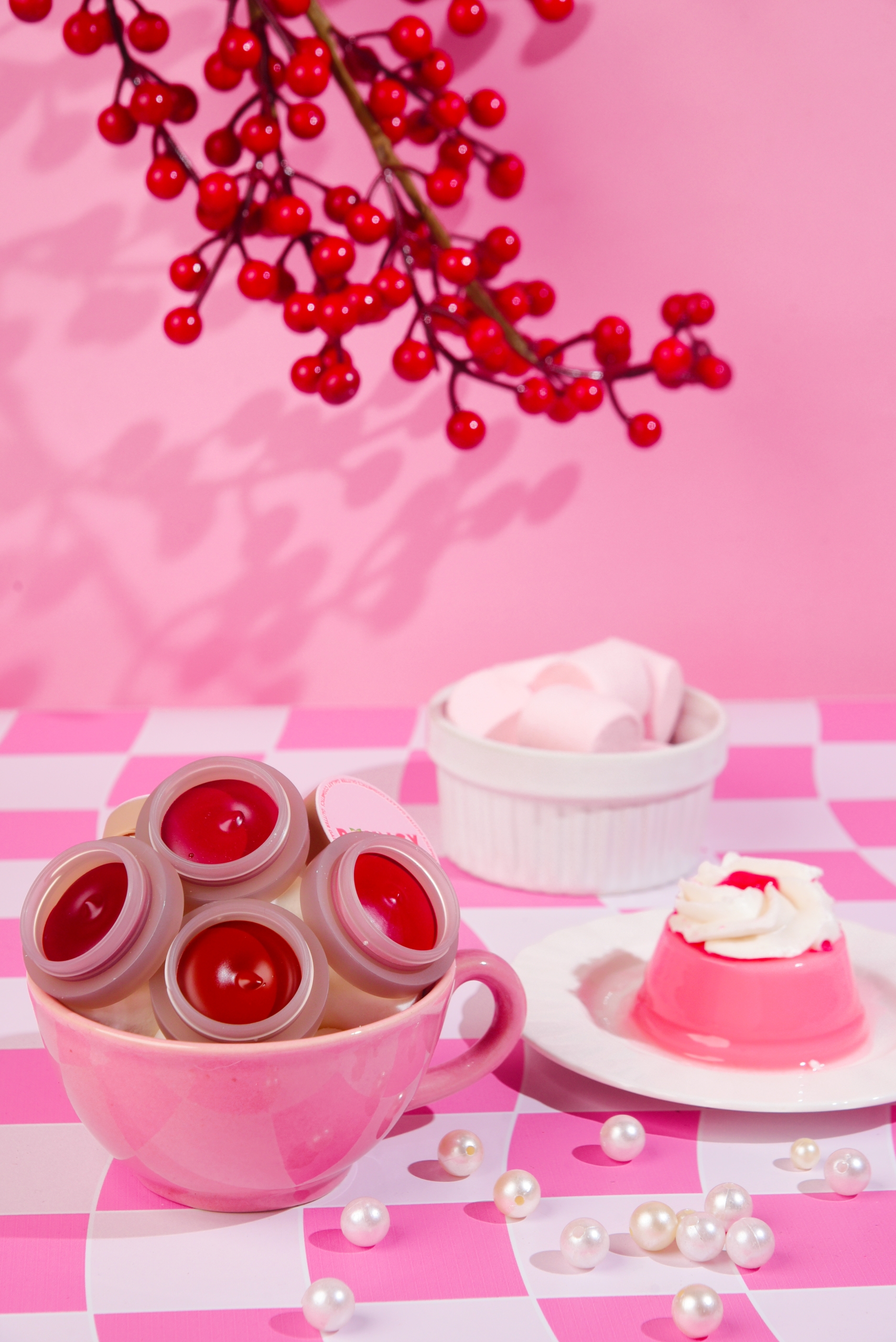 glitter galaxy velvet mousse mud lip and cheek tint collection displayed in a pink cup with vibrant matte lipstick shades for long-lasting everyday makeup.