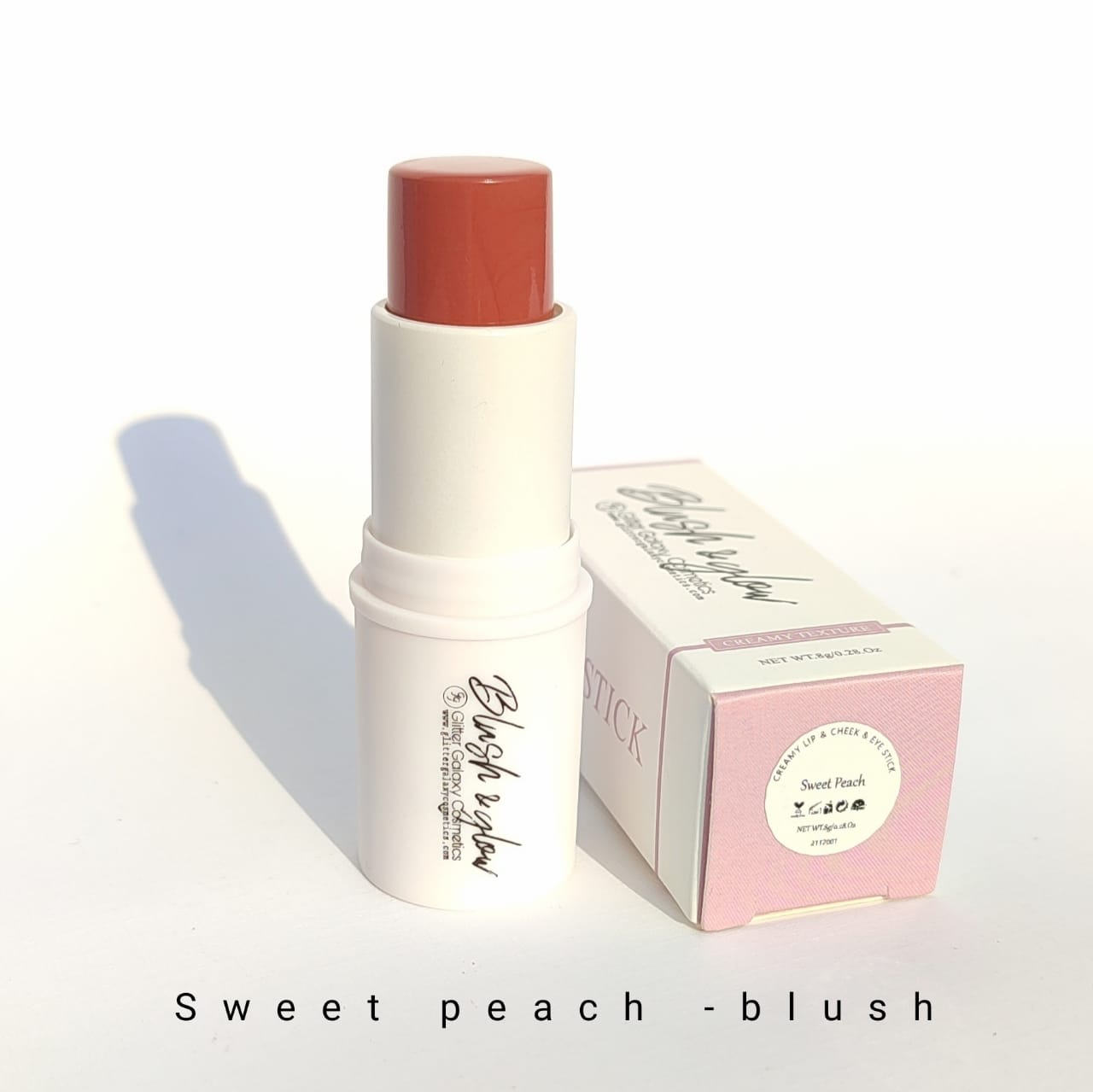 Glitter Galaxy Cosmetics Sweet Peach Blush Stick featuring a creamy peach-toned blush in a twist-up stick with soft matte packaging for natural radiant makeup.