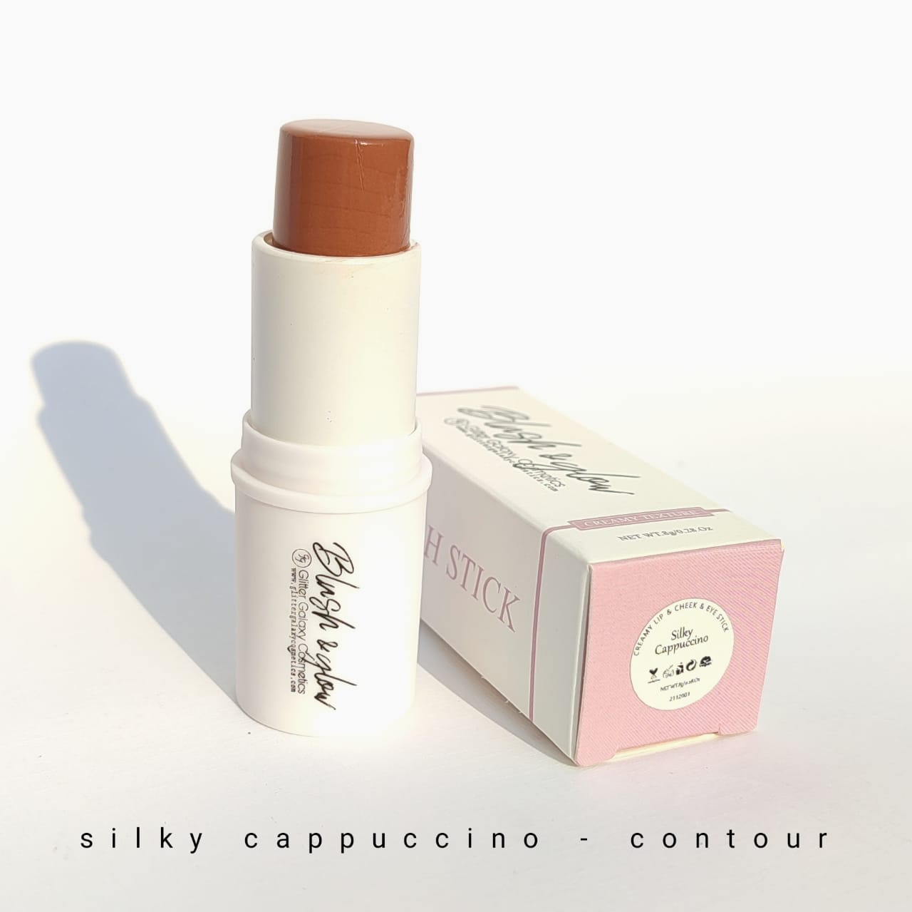 Glitter Galaxy Cosmetics Silky Cappuccino Contour Stick featuring a creamy warm brown contour in a twist-up stick with elegant pastel packaging for natural face sculpting.