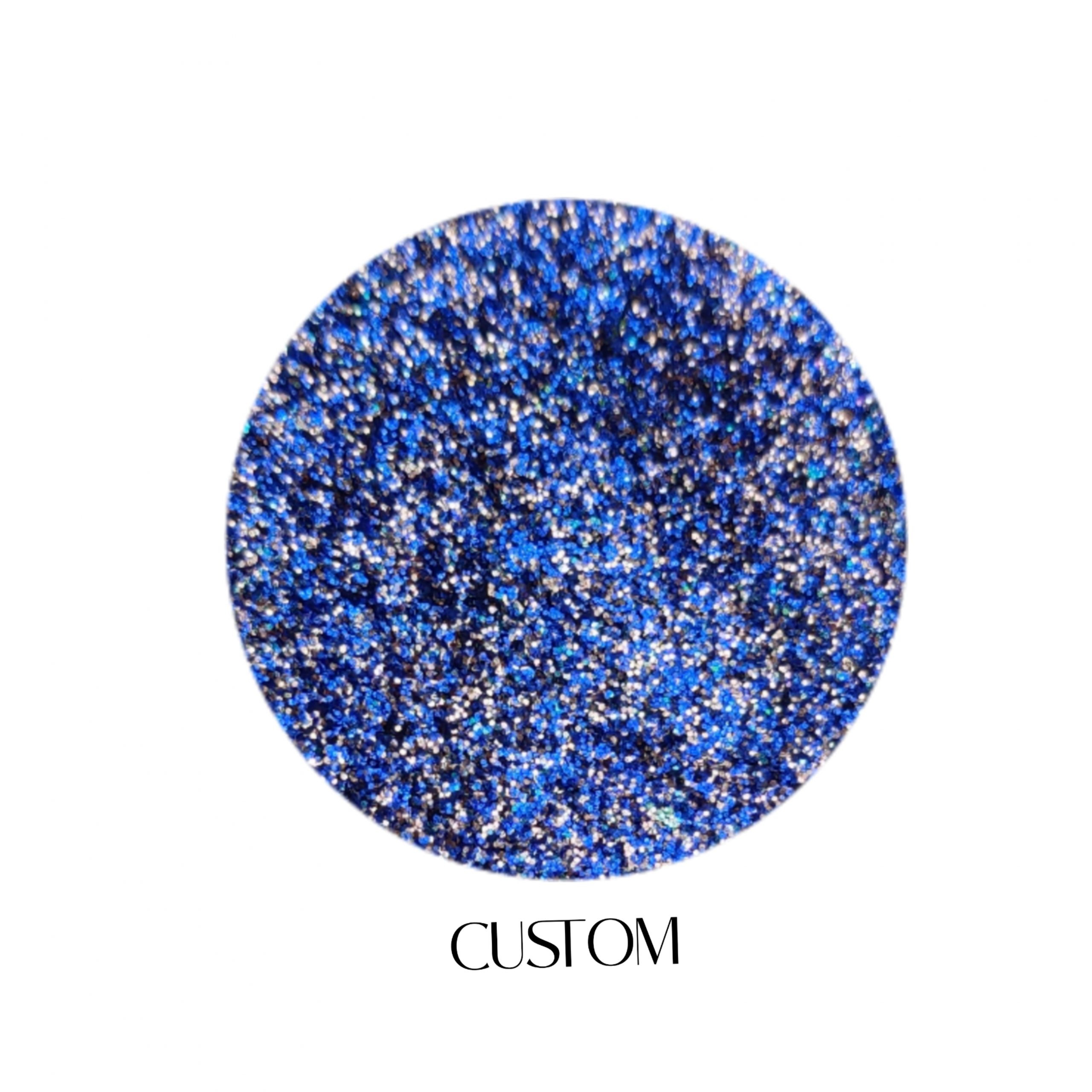Glitter Galaxy Cosmetics Custom holographic cosmetic glitter featuring ultra-fine royal blue shimmer with sapphire, silver, and rainbow reflective multidimensional sparkle.