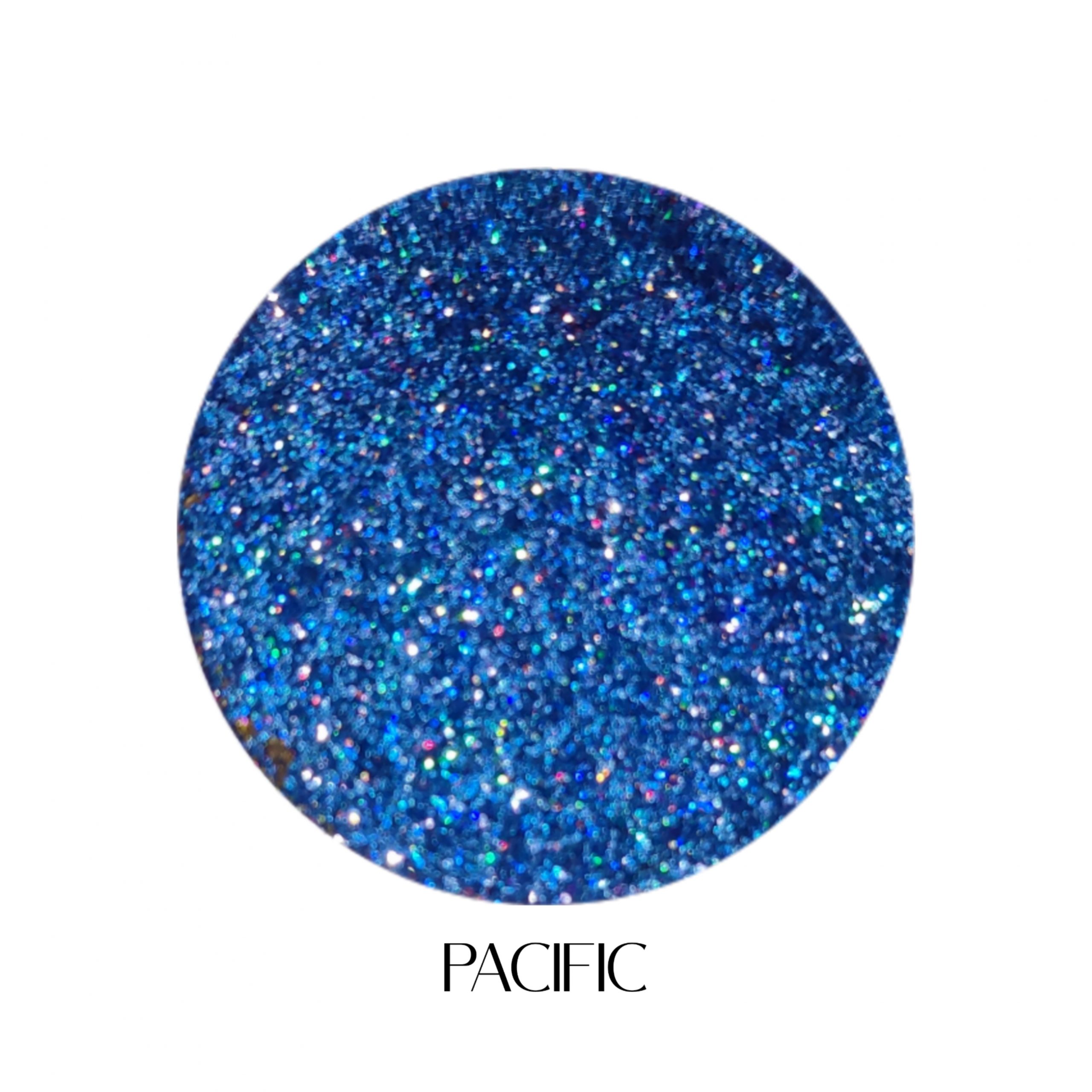 glitter galaxy cosmetics pacific holographic cosmetic glitter featuring ultra-fine sapphire blue shimmer with vibrant rainbow reflective multidimensional sparkle.