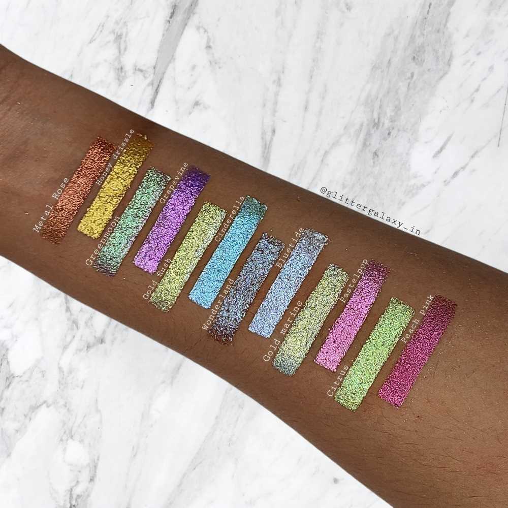 Glitter Galaxy multichrome glitter eyeshadow swatches featuring holographic shimmer pigment shades with metallic reflective color-shift finish on arm.